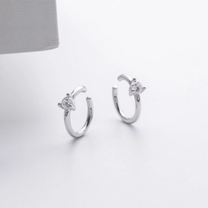 Detailed macro of S925 sterling silver C-shaped ear cuffs with micro-set zircon stones