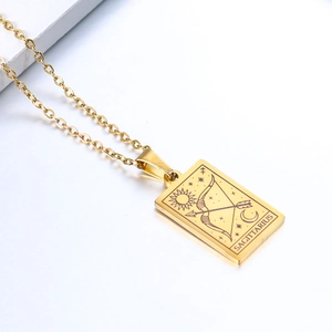 Detailed close-up of gold Sagittarius constellation pendant with sun and arrow engraving