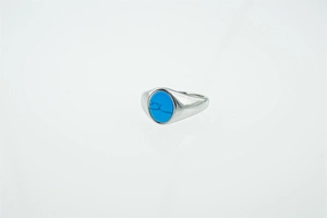 Macro view of vintage titanium steel ring featuring oval turquoise with black veins