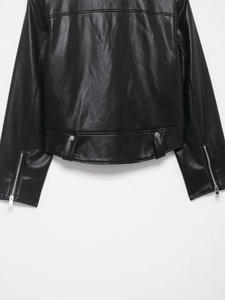 Detail of black motorcycle jacket back featuring pebbled leather texture and silver zipper