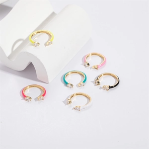 Macro detail of colorful enamel open rings with water drop zircon in gold base