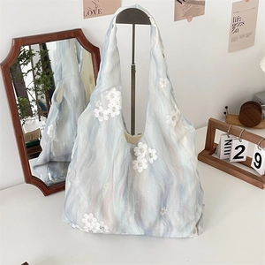 Detailed view of blue aesthetic tote bag featuring 3D flower appliqués and sequins