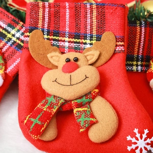 Close-up of a red fabric Christmas stocking featuring a 3D cartoon reindeer and snowflake