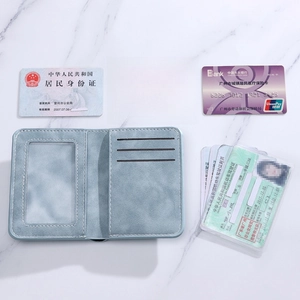Slim light blue PU leather card holder with multiple slots and ID window on marble