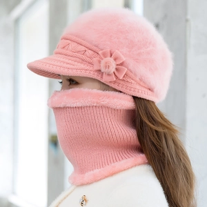 Detailed texture of pink knitted hat and neck gaiter set with floral embellishment