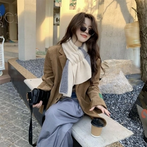 Chic winter knit scarf with beige and grey color-blocking paired with corduroy jacket