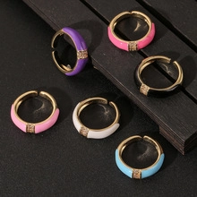 Detail view of colorful adjustable star rings with enamel finish and small crystals
