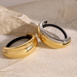 Minimalist U-shaped stainless steel hair rings in gold and silver finish on stone