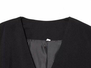Gros plan détaillé du col en V sur combinaison noire montrant la texture du tissu