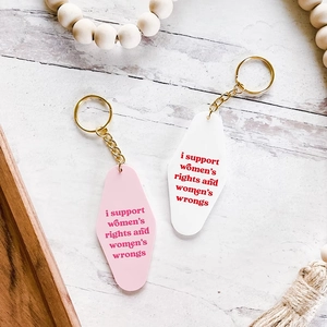Retro diamond-shaped acrylic keychains with funny feminist quotes in pink and white