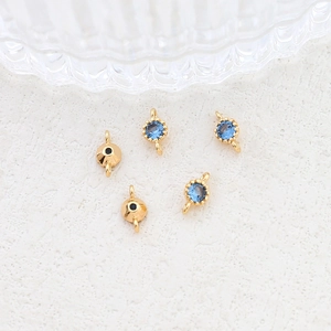 Detailed view of gold-plated connectors with blue zircon for DIY jewelry making