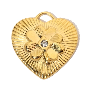 Detailed view of heart-shaped hollow pendant with clover design and central crystal