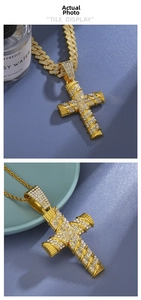 Detail of iced out gold cross pendant with Cuban link and rope chain necklace