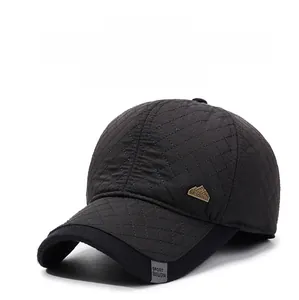 Close-up of quilted baseball cap with warm ear flaps and mountain emblem detail