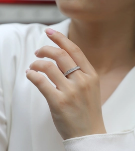Close-up of S925 sterling silver moissanite eternity ring worn on a finger