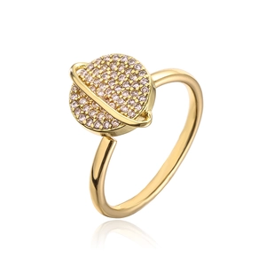 Macro detail of gold-plated Saturn ring with pavé-set pink cubic zirconia stones
