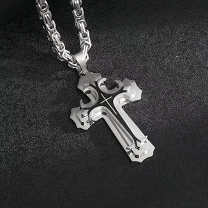 Detail of silver Byzantine chain with double-layered cross pendant on black background