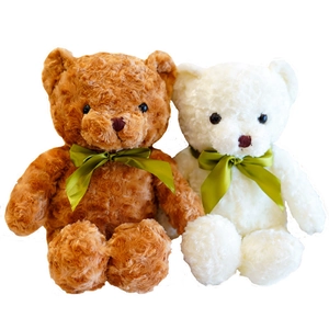 Pair of soft plush teddy bears in brown and white with elegant green satin bows