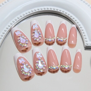 French tip press-on nails with pink gradient, rhinestones, and 3D crystal bows