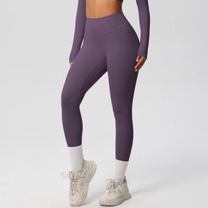 Close-up of dark purple high-waisted yoga leggings with wide waistband for tummy control