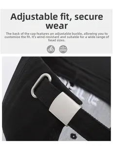 Detail of adjustable silver metal buckle on black cotton twill baseball cap