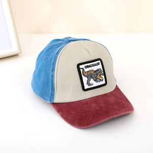 Close-up of kids dinosaur embroidery patch on a tricolor contrast baseball cap