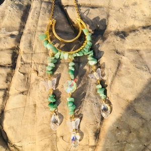 Detailed moon suncatcher with green crystal chips and butterfly drops on stone