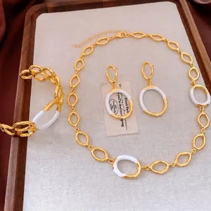 Vintage gold and white enamel circular link jewelry set with necklace and bracelet