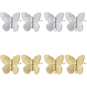 Macro view of gold and silver butterfly earring studs and DIY jewelry components