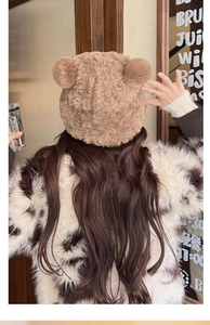 Detail of plush brown bear ear hat with soft faux fur texture and 3D ear design