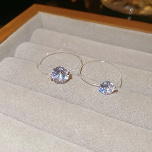 Detail of cubic zirconia rings with invisible bands on gray velvet display padding
