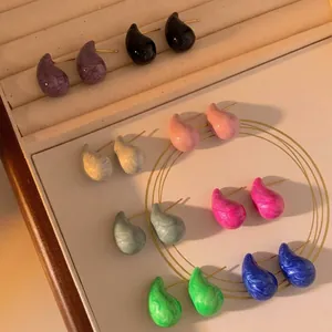 Colorful marble pattern teardrop earrings in stainless steel displayed in a jewelry box