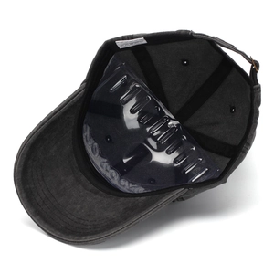 Detail view of washed cotton baseball cap interior with adjustable strap and sweatband