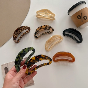 French style oversized acetate hair claws in tortoise, marble, and cream colors