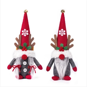 Set of two Christmas gnomes with reindeer antlers, snowflake hats and bells