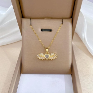 Elegant gold titanium necklace featuring a heart pendant with zircon wings in a jewelry box
