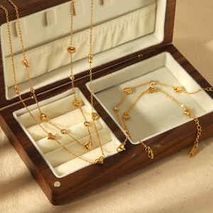 Detail of 18k gold plated heart zircon necklace and bracelet set on a velvet jewelry box