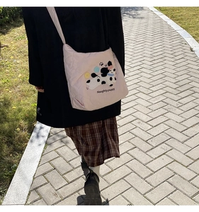 Outdoor street style shot of pink quilted tote bag with dalmation puppy embroidery