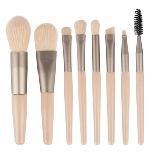 8-piece mini makeup brush set with beige wooden handles and champagne metal ferrules