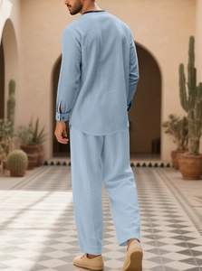 Detail view of light blue linen long sleeve shirt and trousers set on a male model