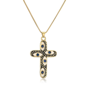 Macro shot of 18K gold plated cross pendant with blue zircon evil eye detail