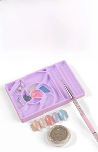 Detailed view of purple plastic nail art palette with mixing slots and brush holder