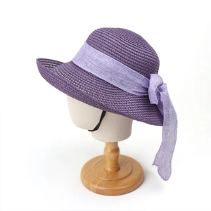 Detail of purple straw sun hat showing rich texture and lavender linen ribbon tie