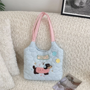 Detailed close-up of quilted tote with puppy embroidery and colorful button accents