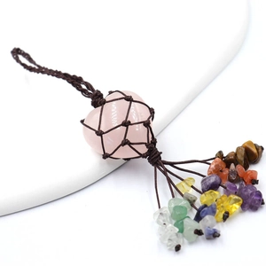 Handmade rose quartz heart pendant with colorful raw stone tassels on white stand