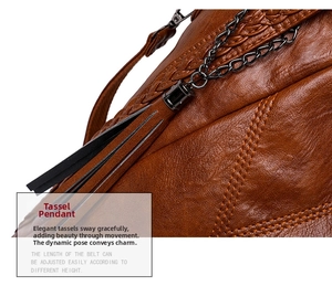 Detail of dark brown pebble leather bag featuring leather tassels and grey metal chain