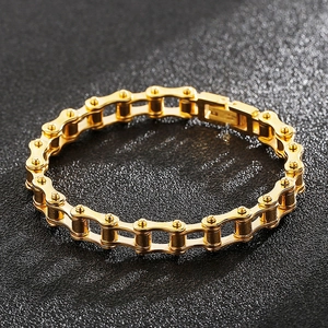 Detailed close-up of golden bicycle chain style bracelet in industrial design with high polish