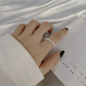 Elegant baroque freshwater pearl ring featuring a minimalist beaded design on finger