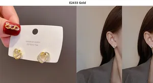 Macro detail of gold-plated heart-shaped earrings with sparkling cubic zirconia inlay