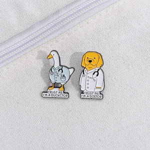Cartoon enamel pins featuring doctor duck and dog characters on white canvas